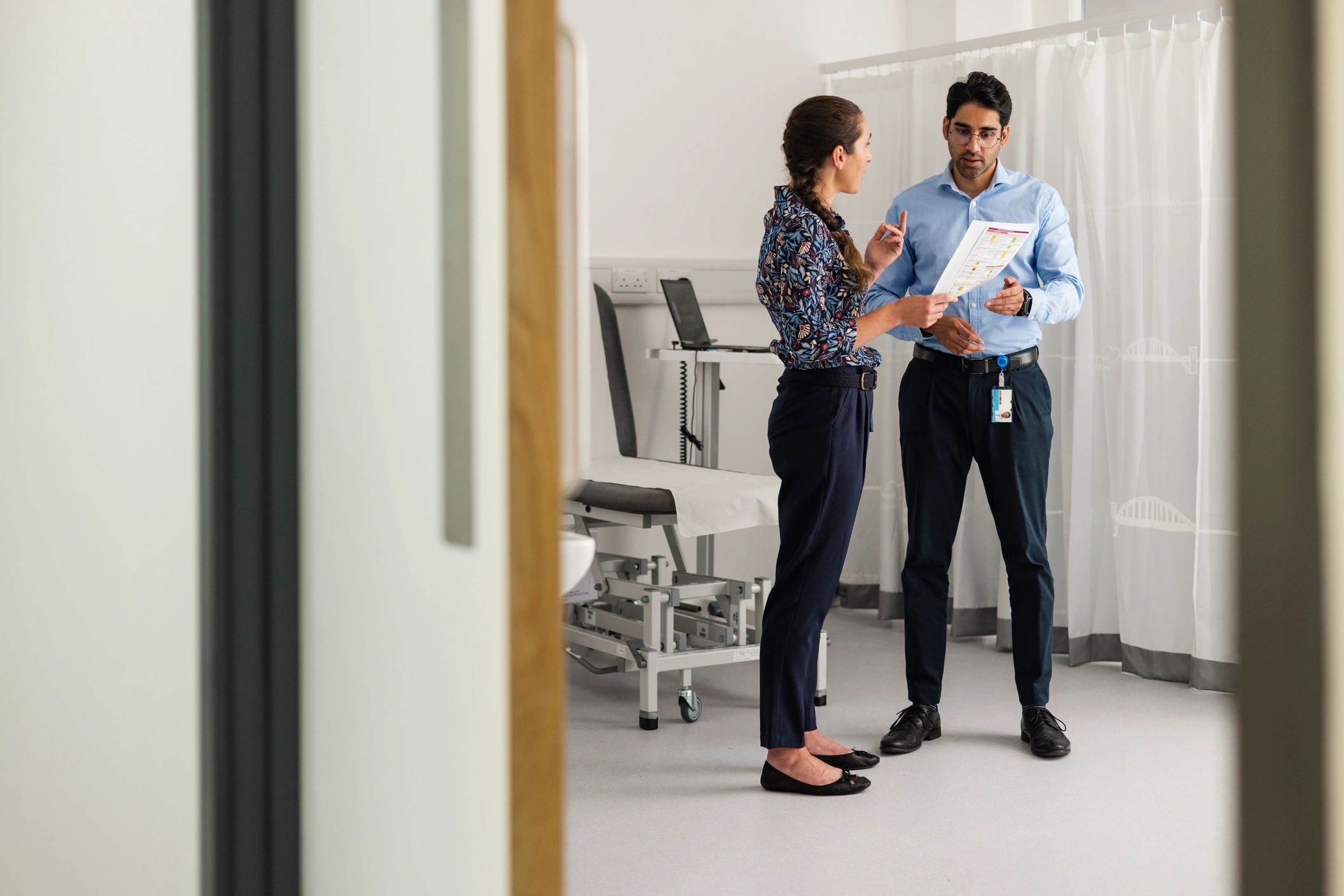 Two professionals discussing healthcare options in an office